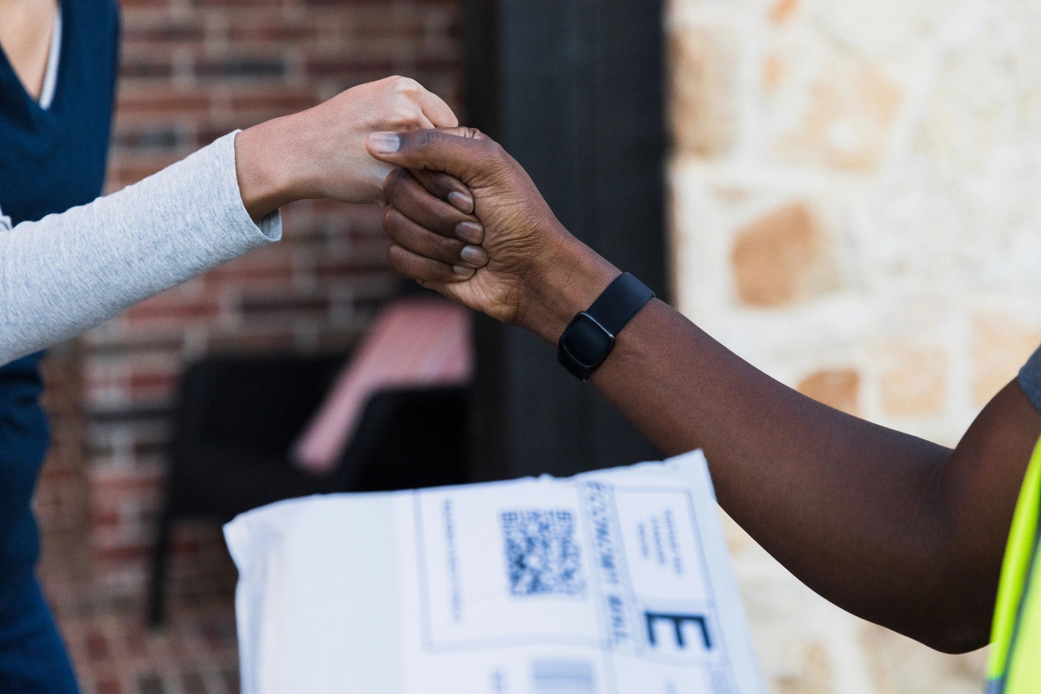 Two people greeting with a fist bump representing partnership