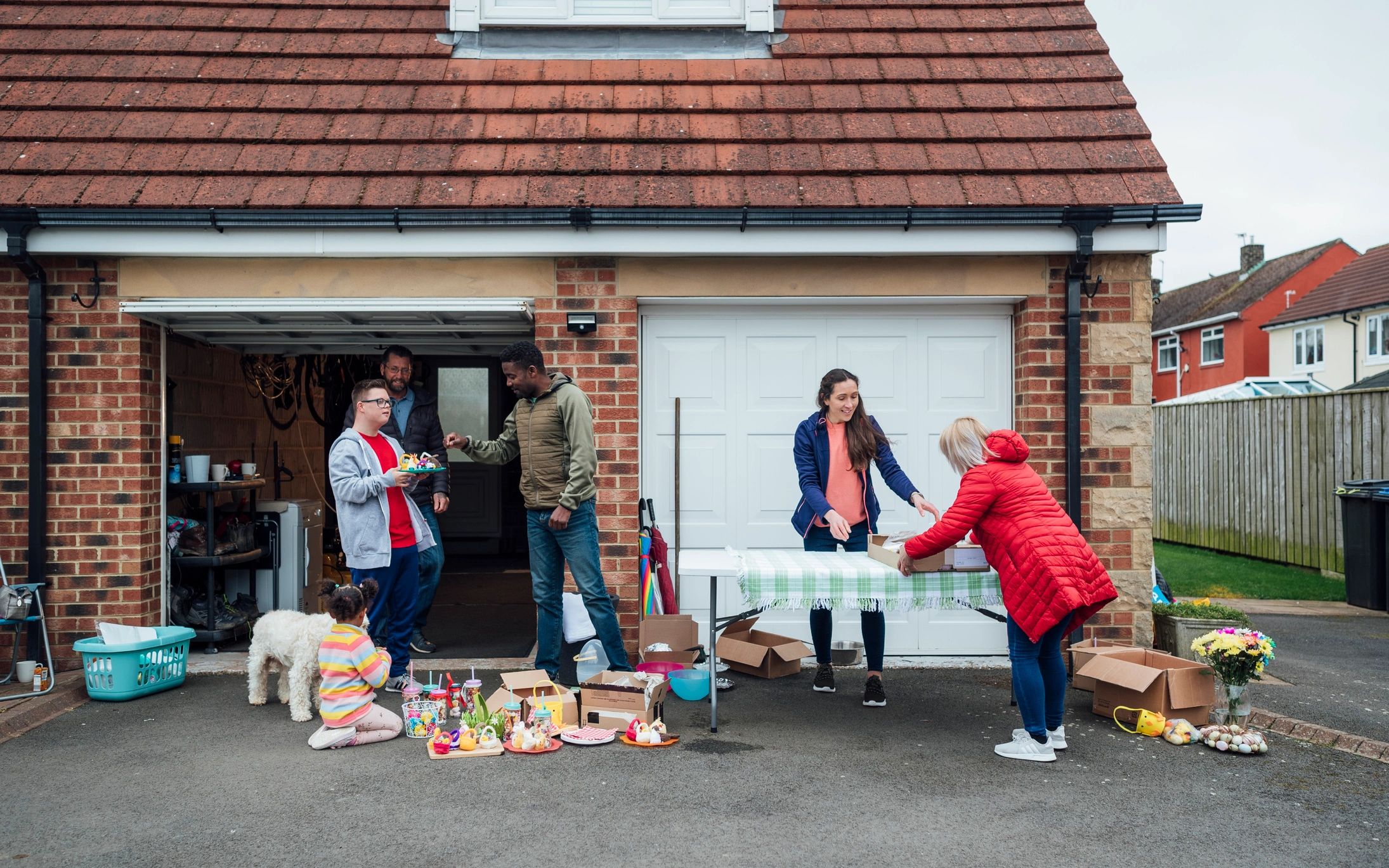 Community members setting up a charity sale table