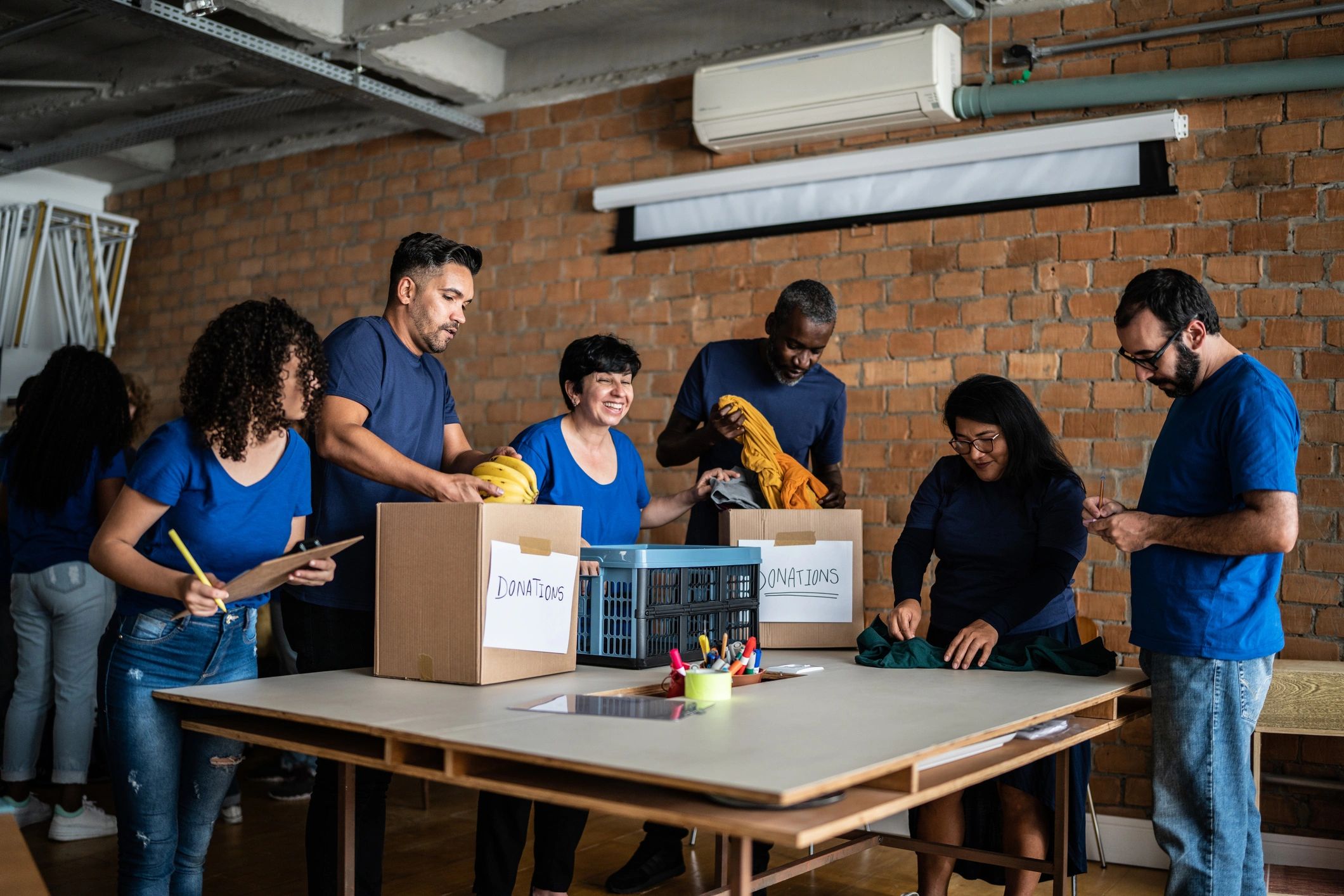 Volunteers organizing donated items at a community center